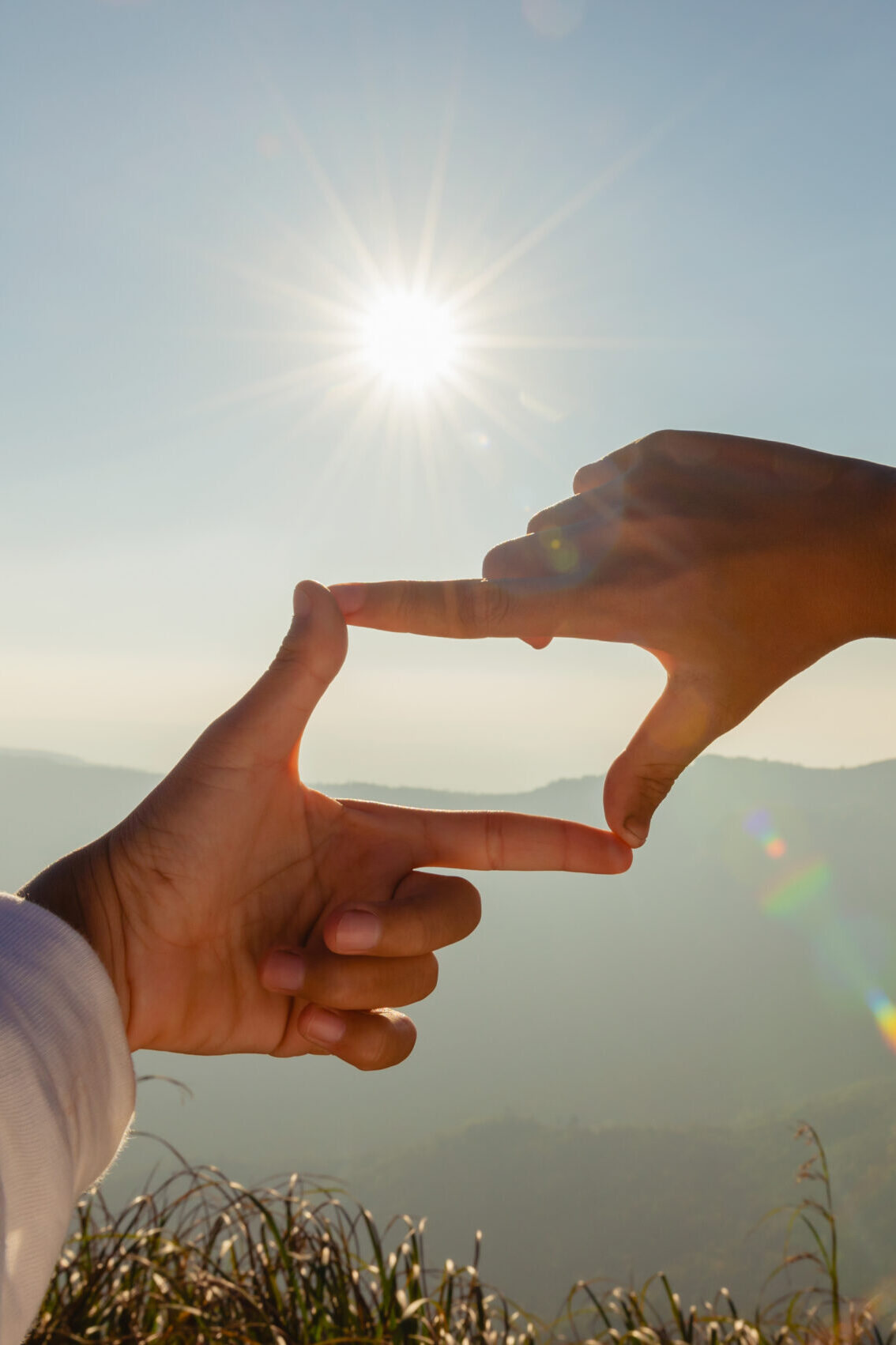 Primrose Watson – Perspective Hands framing a new perspective looking at sunrise